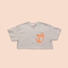 Load image into Gallery viewer, white short sleeve crop t-shirt with the face print in orange