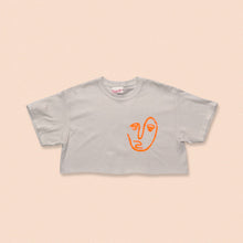 Load image into Gallery viewer, white short sleeve crop t-shirt with the face print in orange
